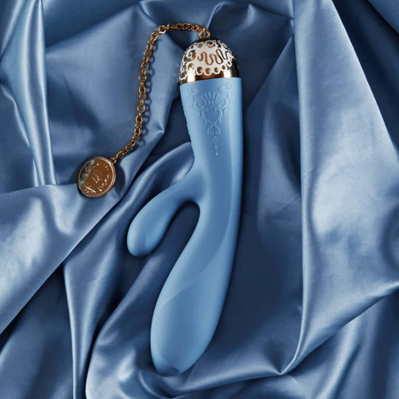 Rosalie 24K Gold Plated Rabbit Vibrator on satin fabric background, showcasing its luxurious design and features.