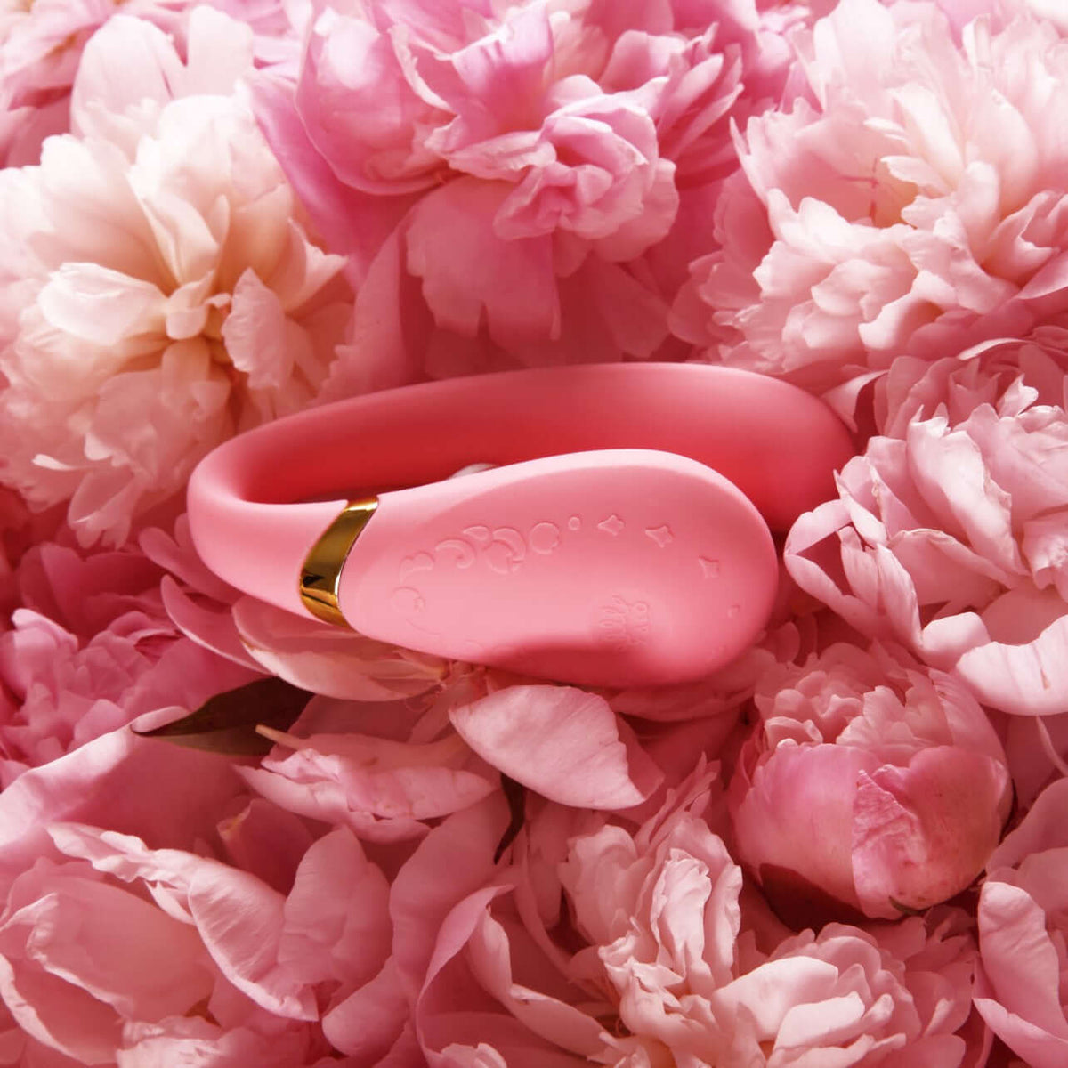 Fanfan Smart Couples Massager App Control displayed among pink peonies, highlighting its elegant design and playful color.