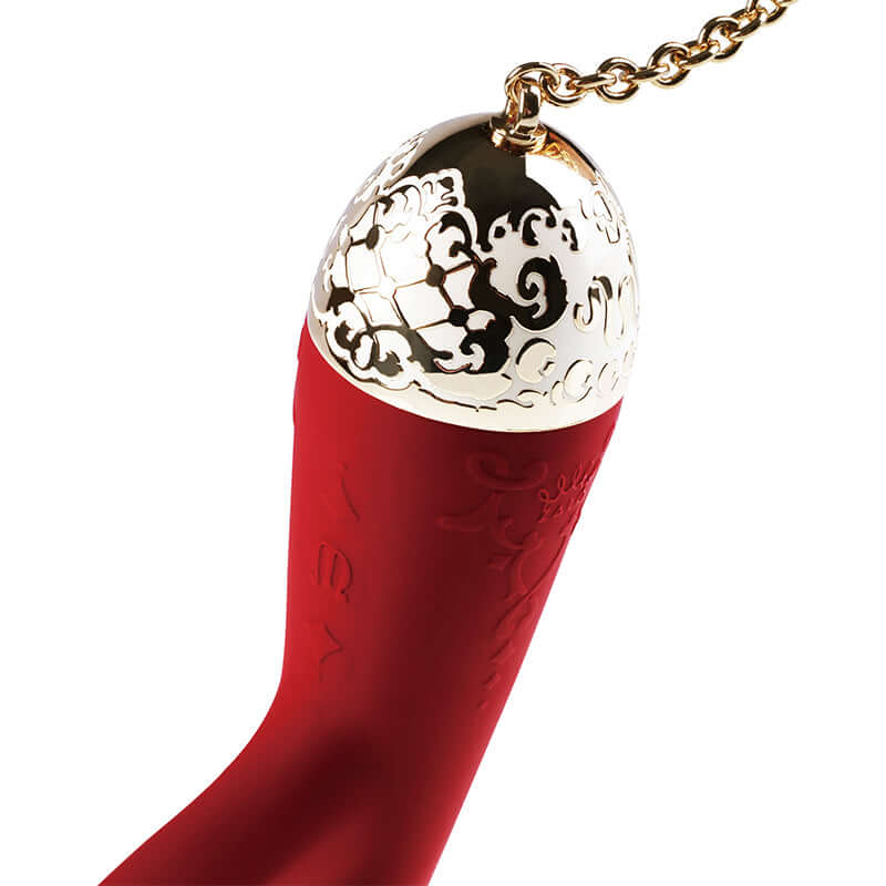Close-up of the Rosalie 24K Gold Plated Rabbit Vibrator showcasing the intricate gold-top design and vibrant red silicone body.